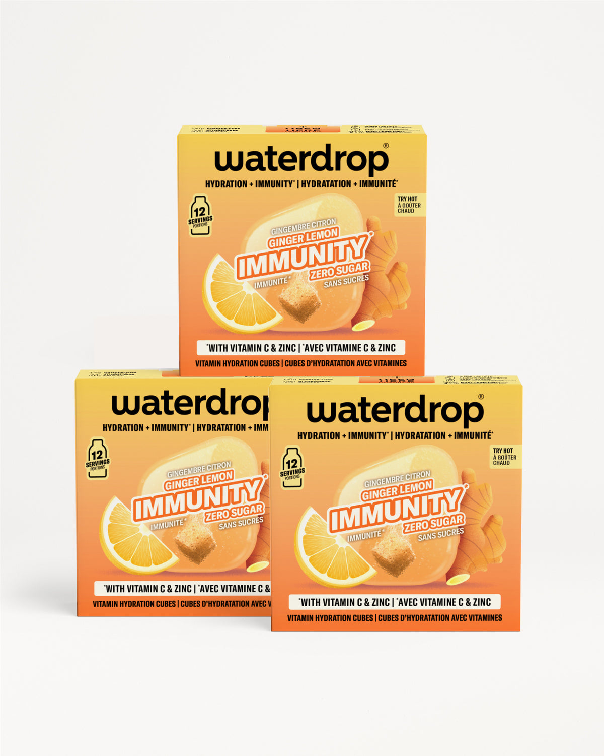 Drei orangefarbene Waterdrop Immunity-Boxen mit Vitamin C und Zink, zu einer Pyramide gestapelt.