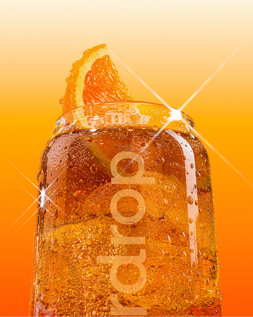 Softdrink Starter Set in einem Glas mit Orangenkeil.