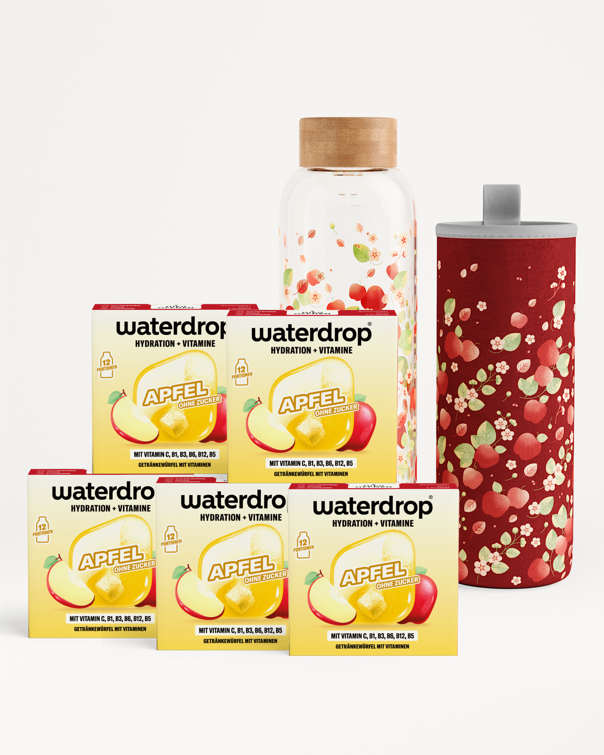 Vier Waterdrop-Boxen für Hydration und Vitamine, eine klare Flasche mit holzner Kappe und ein roter Becher mit Muster.
