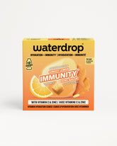 Orangefarbene Waterdrop-Immunbox mit Zitrone und Ingwer Abbildung.