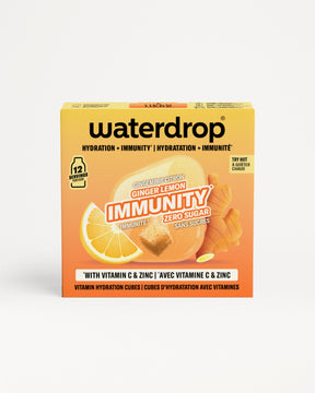 Orangefarbene Waterdrop-Immunbox mit Zitrone und Ingwer Abbildung.