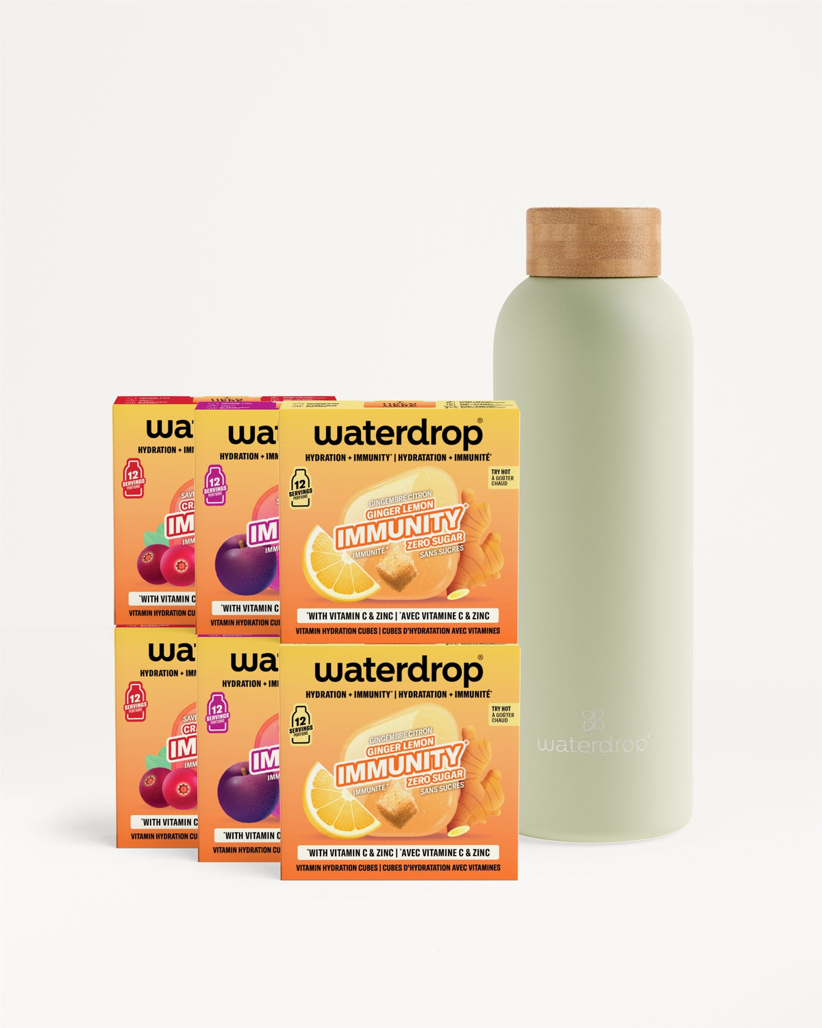 Sechs orangefarbene Getränkemischboxen neben einer hellgrünen Flasche mit Korken.