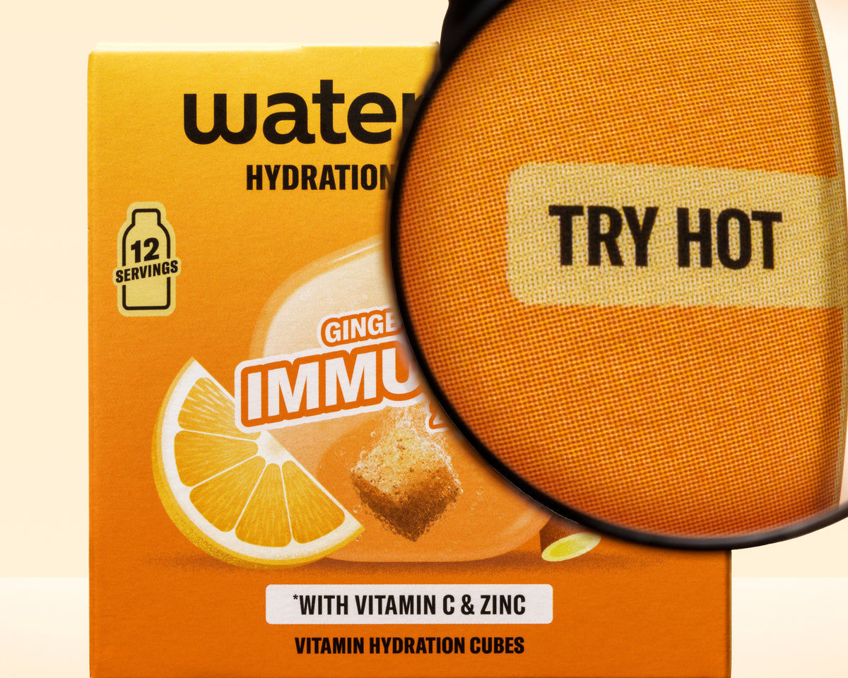 Orangene Box mit Zitronengrafik und Lupenüberlagerung, hervorgehoben Vitamin-Hydration-Cubes.