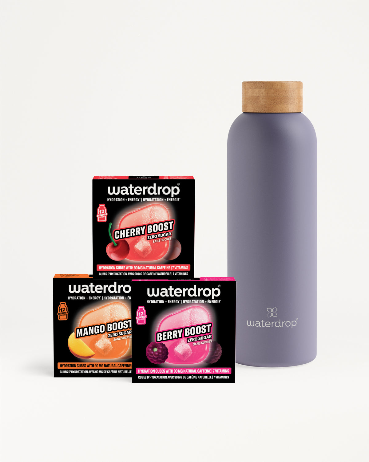 Drei Waterdrop Boost-Boxen neben einer lila Flasche mit Holzdeckel.